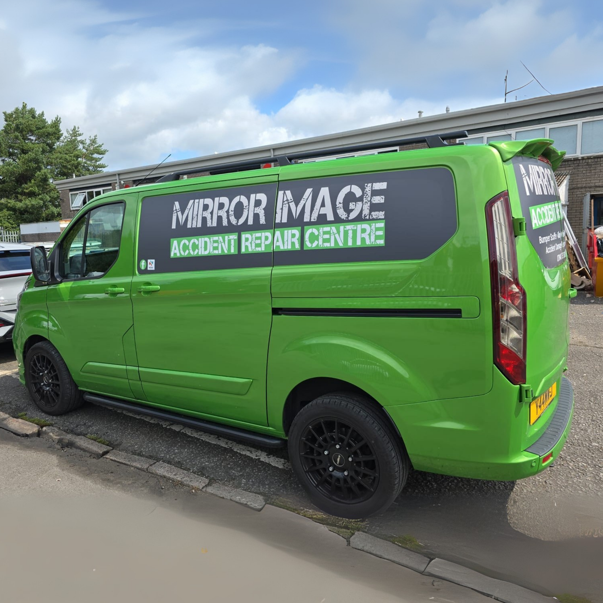 Green van with 'Mirror Image Accident Repair Centre' branding parked on a street.