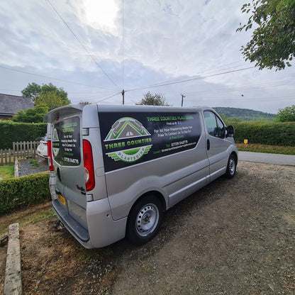 Silver van with branding parked on a driveway