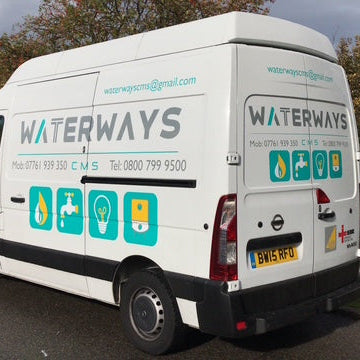 White van with 'Waterways' branding on a road with trees in the background
