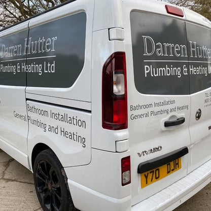 White van with 'Darren Hutter Plumbing & Heating Ltd' branding on a road.